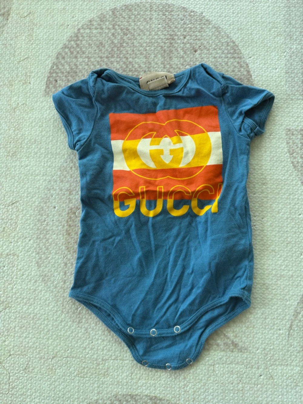 Gucci blue baby one-piece with red, white and yellow logo